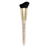 Makeup brush with black bristle tip and gold and beige handle on a white background